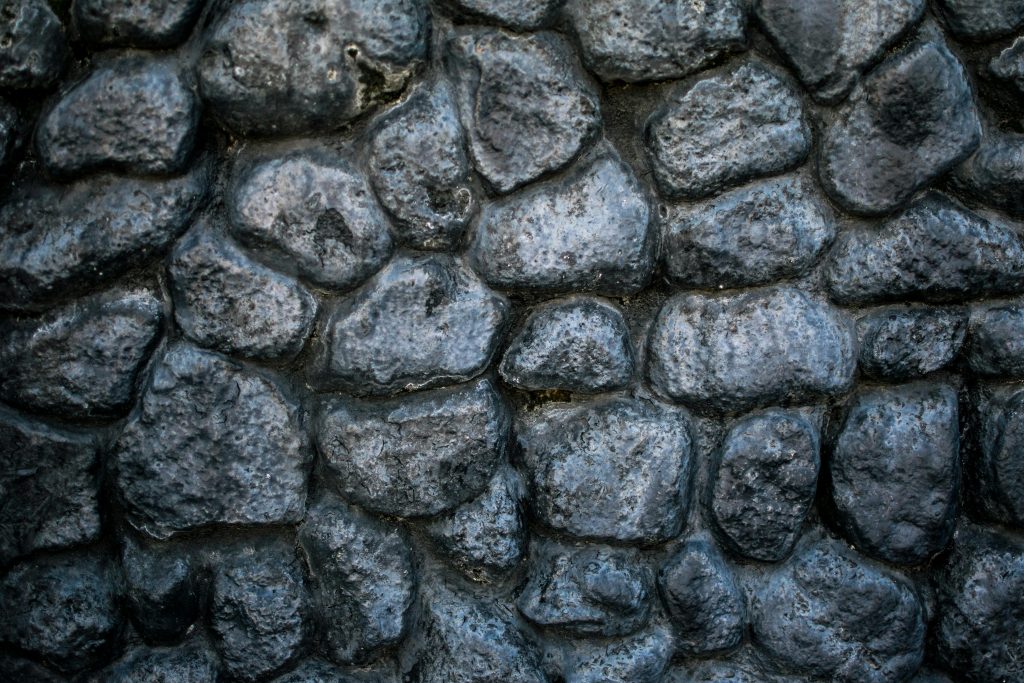 pexels-photo-2463349-2463349 Close-up of a textured stone wall showcasing intricate details and patterns.