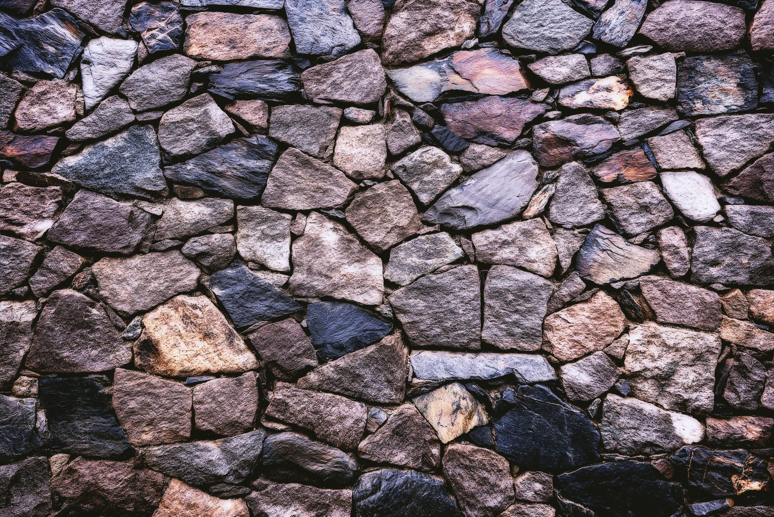 pexels-photo-966927-966927 High-resolution image of a rustic stone wall showing detailed texture and pattern.